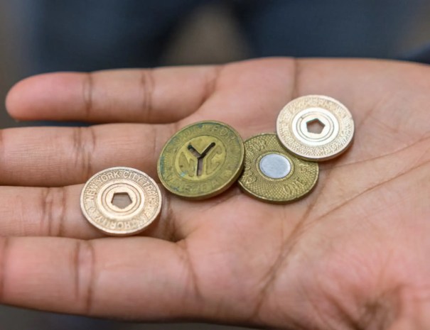 Old subway tokens in guide's hand