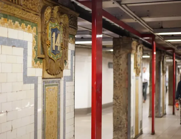 vertical red pillars in subway station