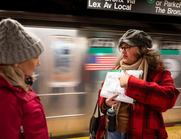 guide showing guests a subway map