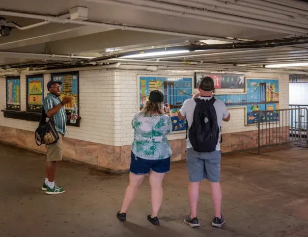 guests taking pictures of art installation in subway