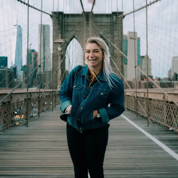 Woman poses on the Brooklyn Bridge