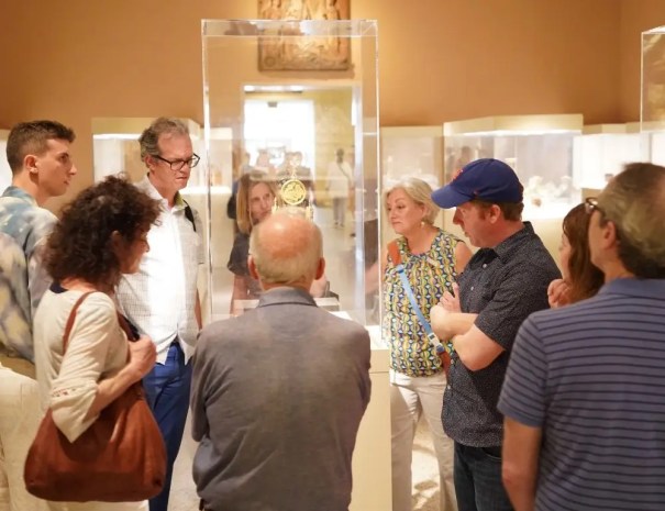 Visitors looking into a display case at Metropolitan Museum of Art