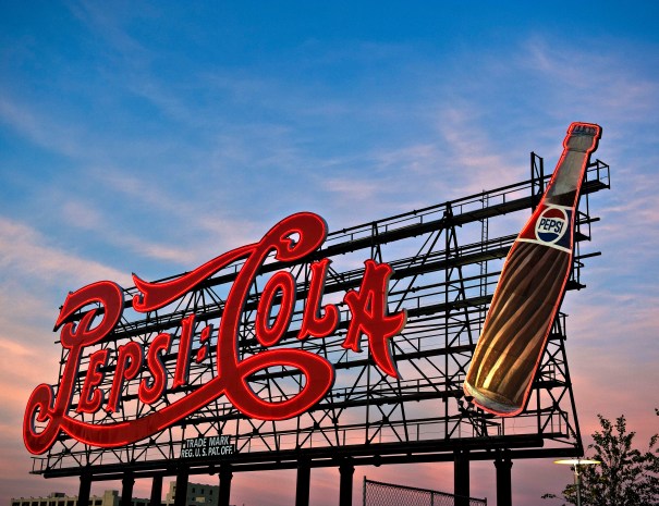 The landmarked Pepsi-Cola neon sign on the Long Island City waterfront at dusk